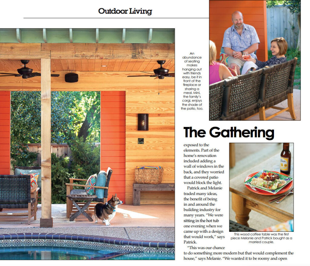 Outdoor patio seating area with an orange lounge chair, colorful cushions, side table, and green ceramic grill beside wood privacy slats.