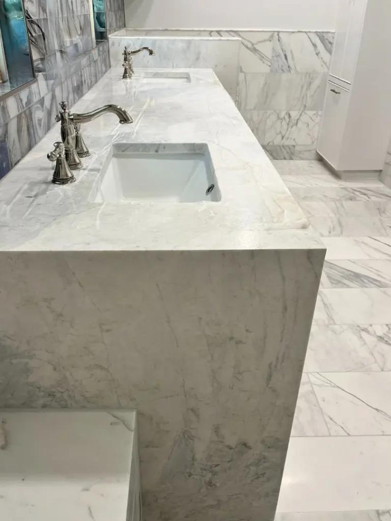 Luxury marble bathroom vanity with integrated sinks and polished chrome fixtures