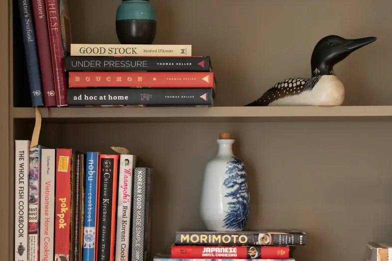 Custom built-in shelving styled with books, ceramics, and decorative accents