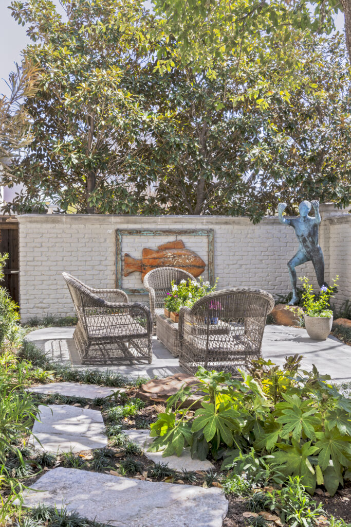 Landscaped outdoor seating area with stone pathway and garden patio at a luxury home