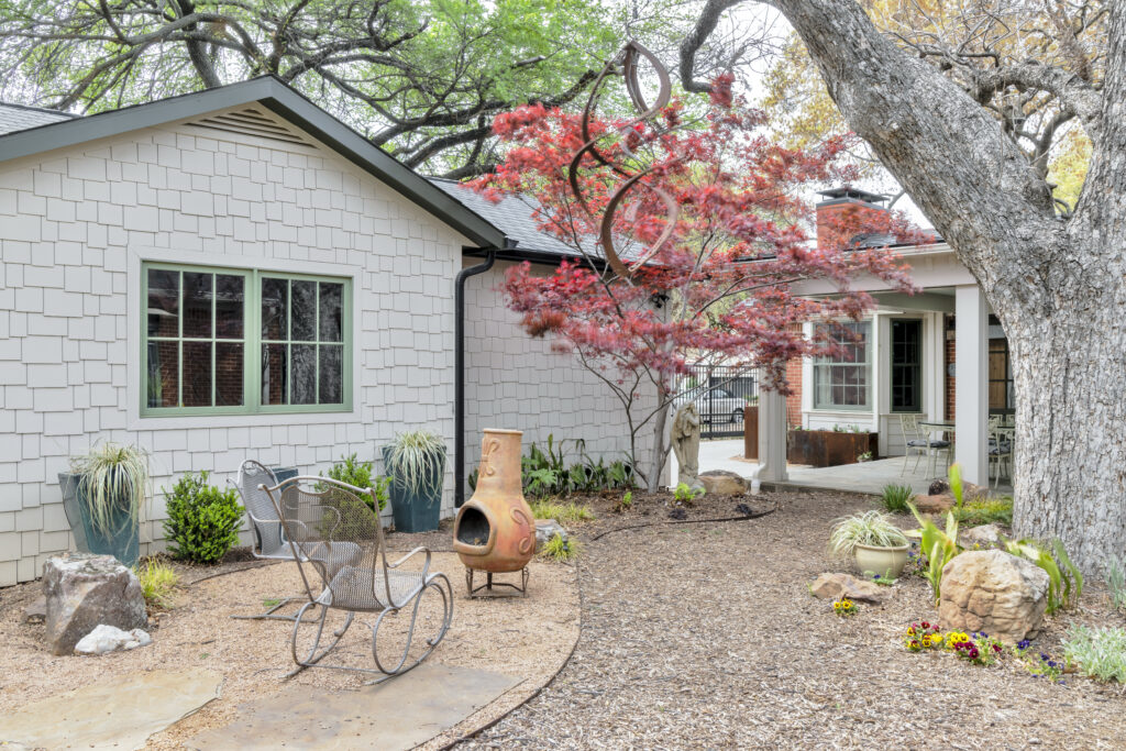 Luxury home exterior with landscaped courtyard and covered patio in Fort Worth, Texas